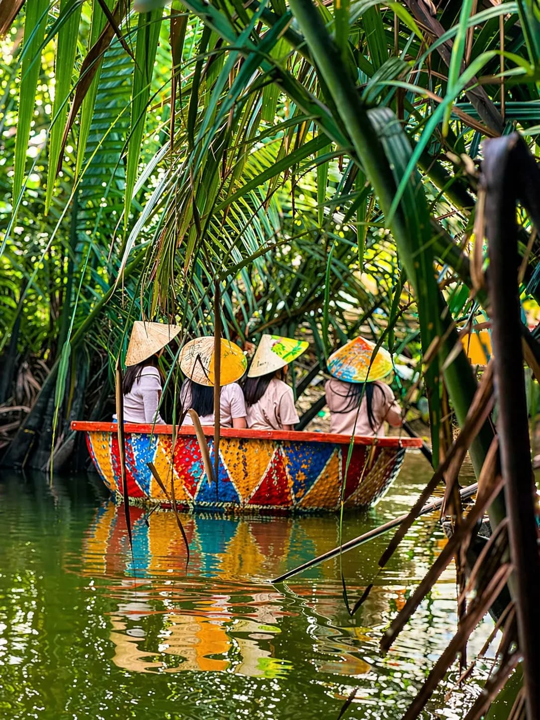 Happy tourists enjoying Coconut Boat Hoi An and Basket Boat Ride experience